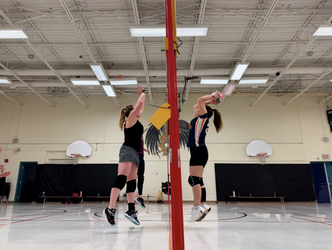 Women spiking at the net